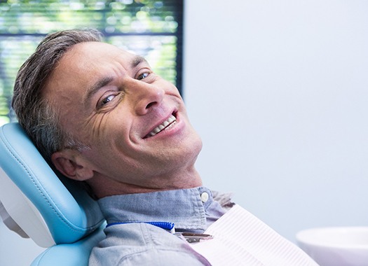 Man with dentures in New Orleans at dentist office 