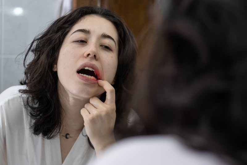 Patient checking their mouth for gum disease