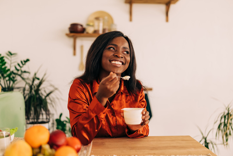 Patient smiling as they eat after teeth whitening